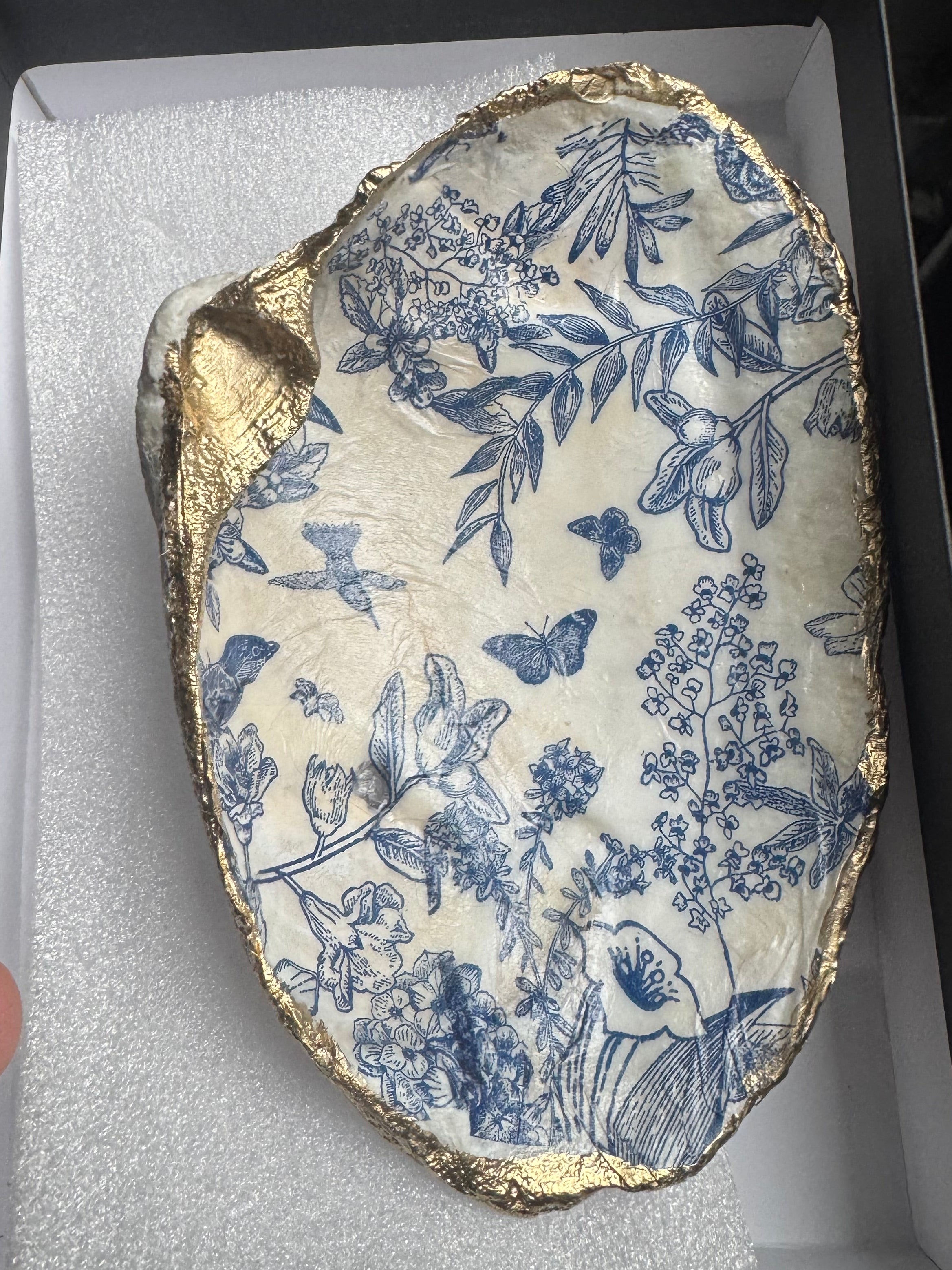 Sea shell with gold paint and blue flowers and butterflies